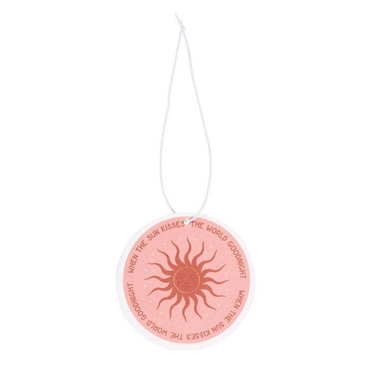 Pink car air freshener with sun design and text on a white background
