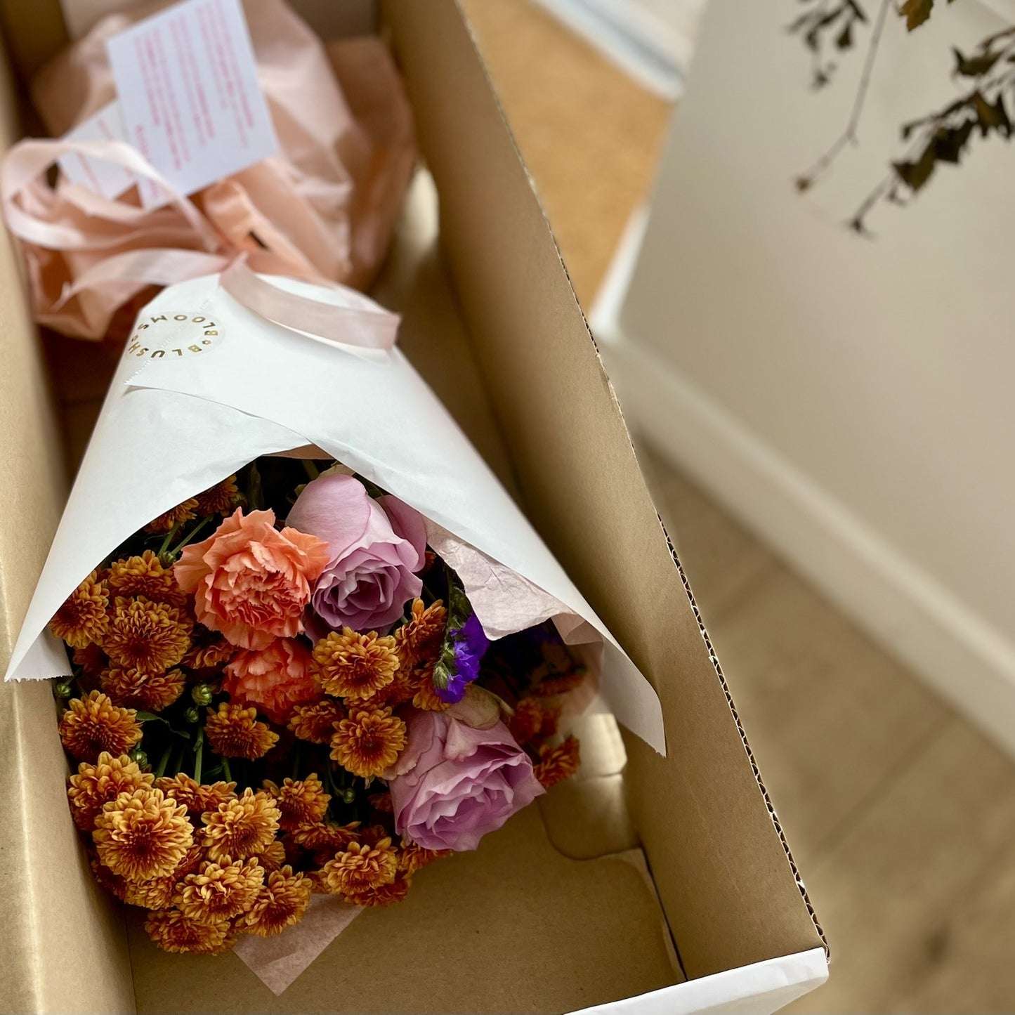 Blush blooms bouquet in box ready for postal delivery