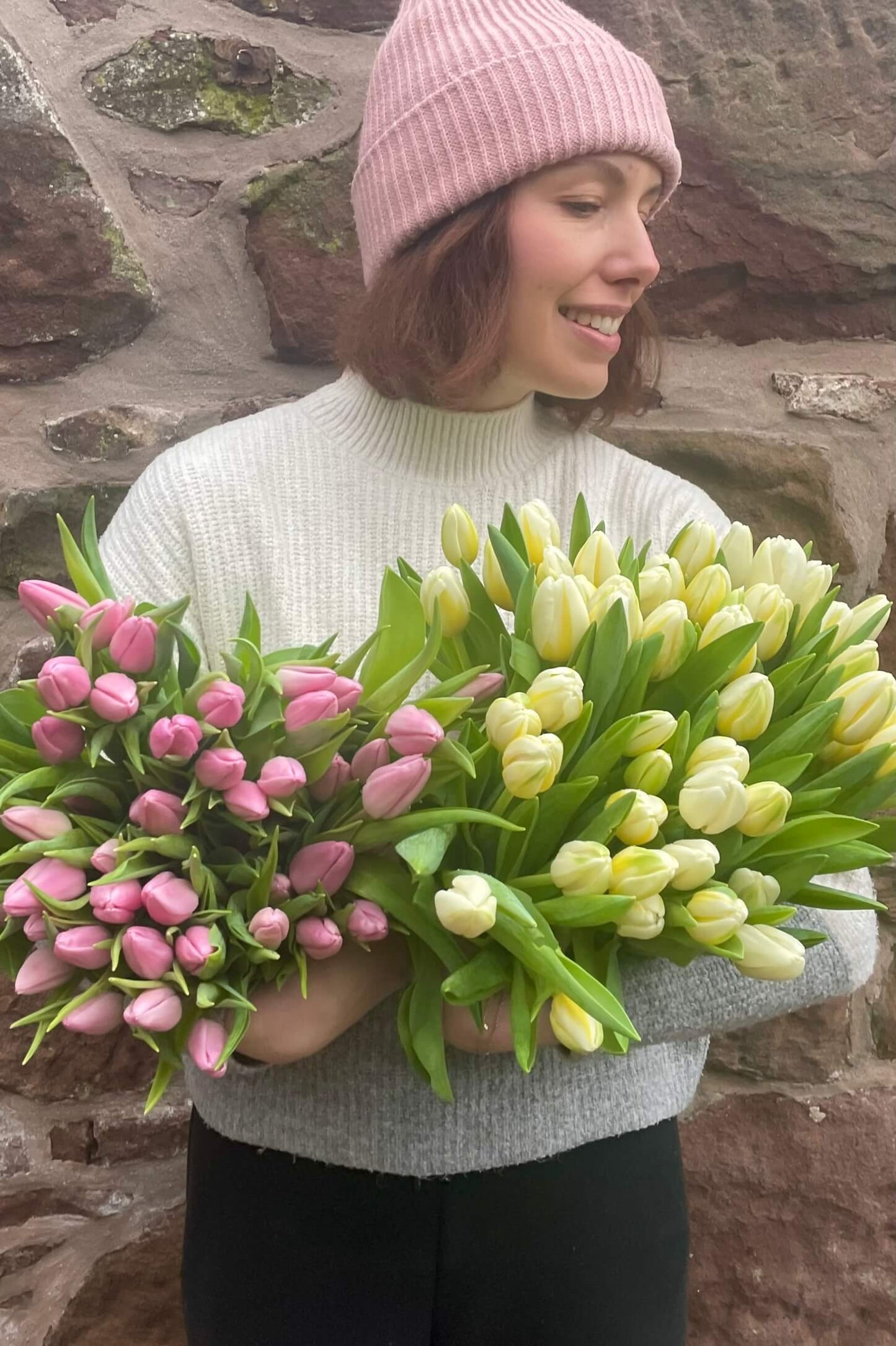 Cream and pink tulips held in large bunches, showing a seasonal mix of tulips from Blush Blooms