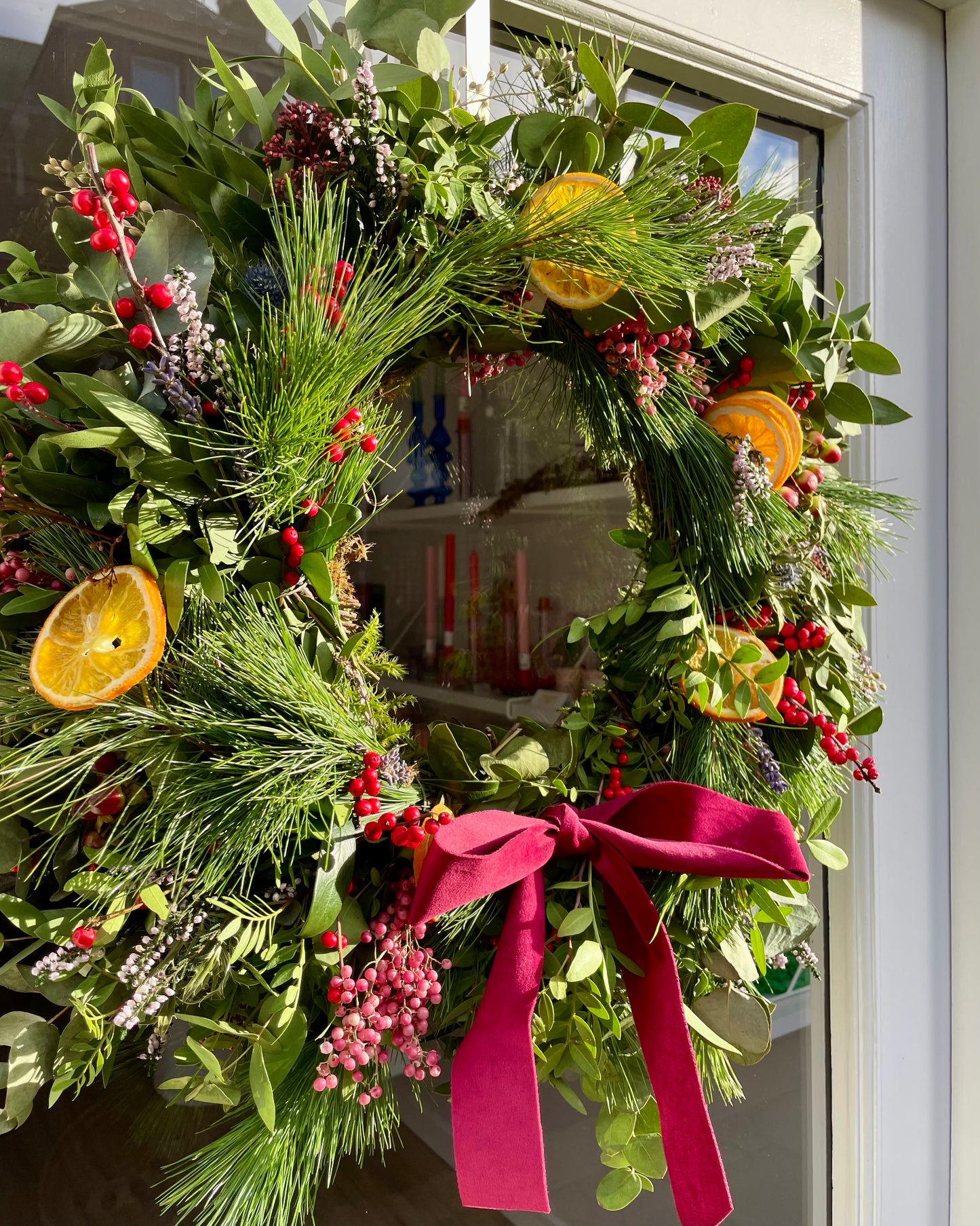Closeup of the Noel Fresh Luxury Wreath on the door of Blush Blooms florost on Stonehaven