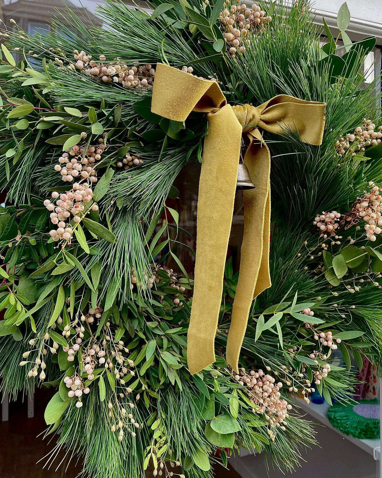 Close up of The Nordic Fresh Luxury Wreath on the door of Bush Blooms the florist in Stonehaven
