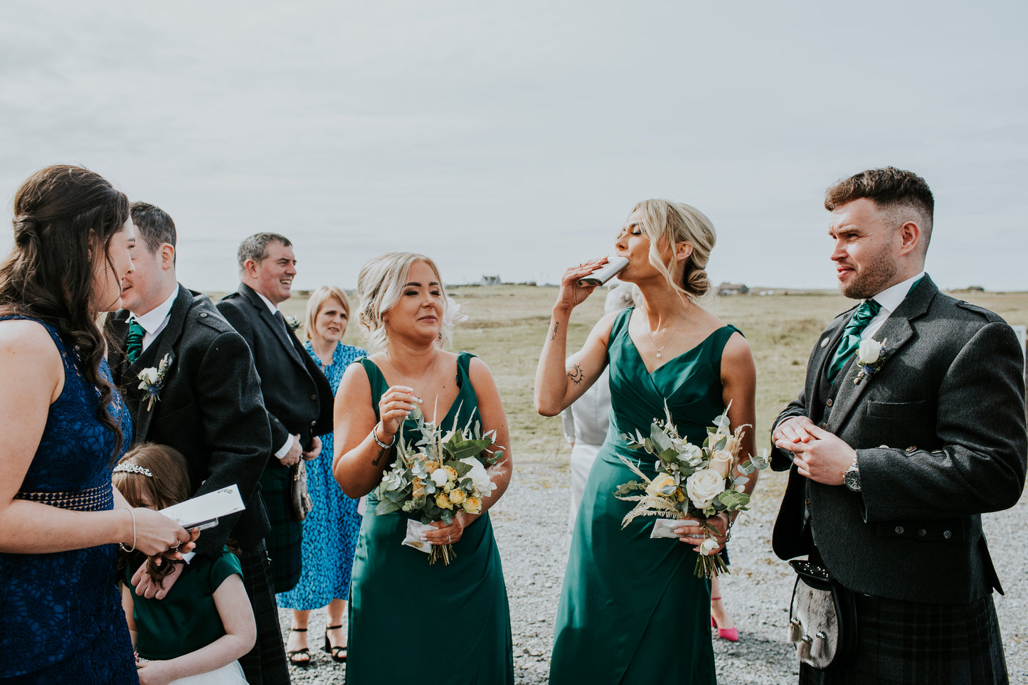 Wedding party in formal attire with bouquets 