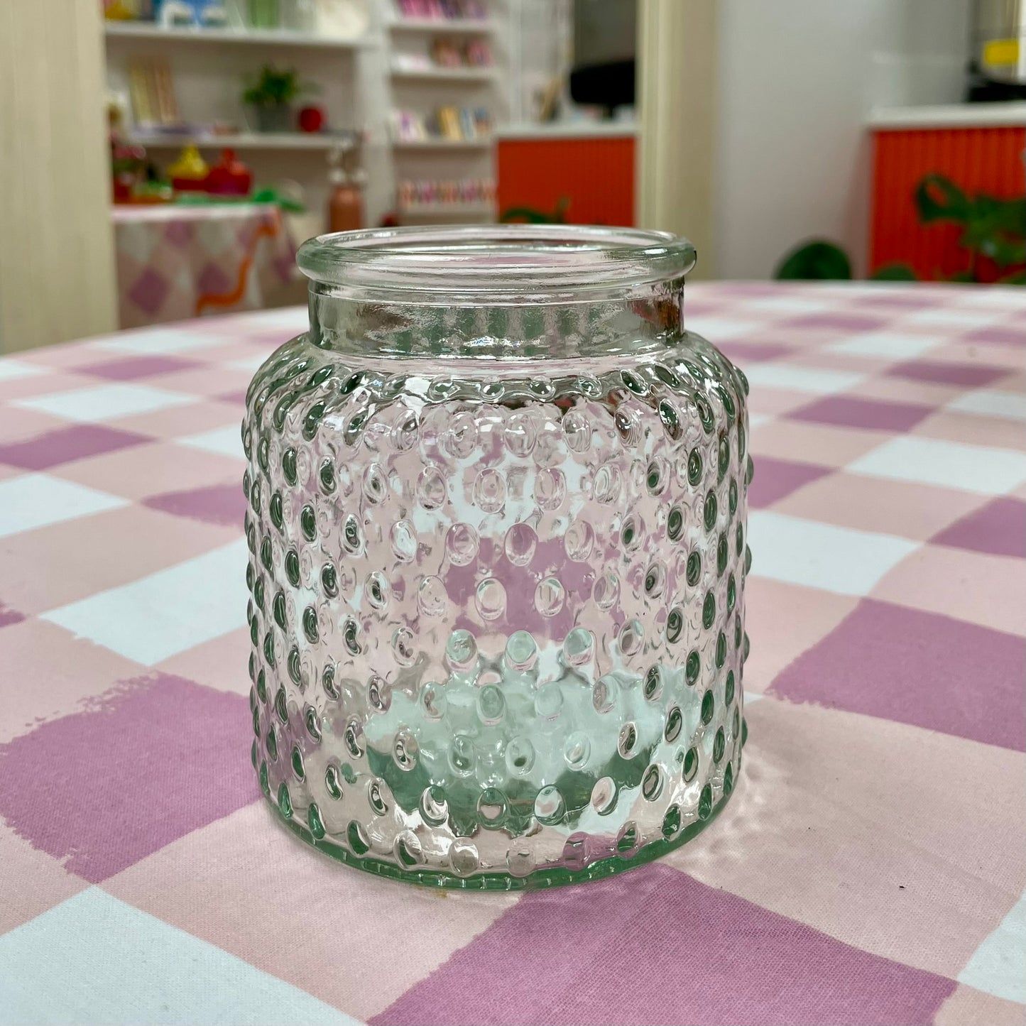 Clear dimpled glass jar on a checkered tablecloth in Blush Blooms