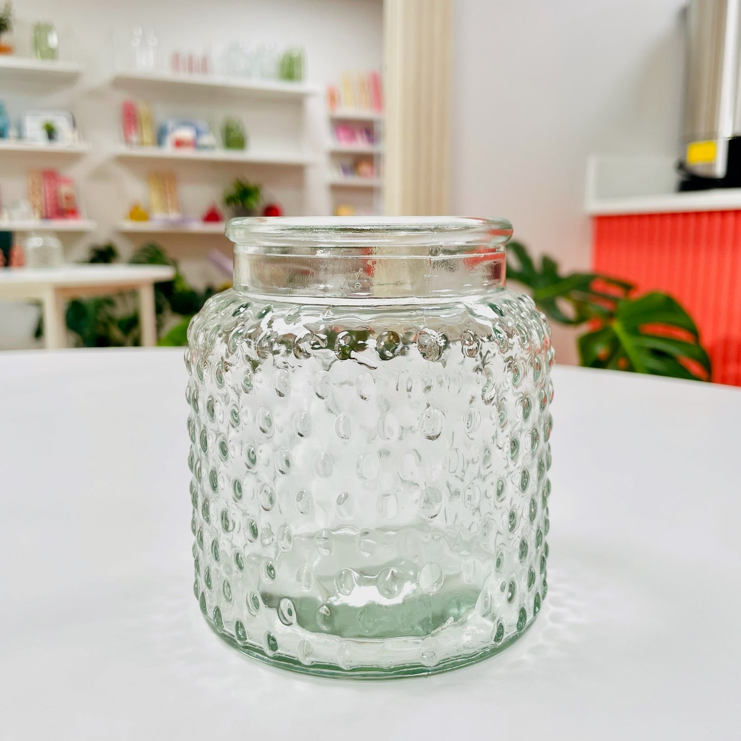 Small clear dimpled clear glass vase on table