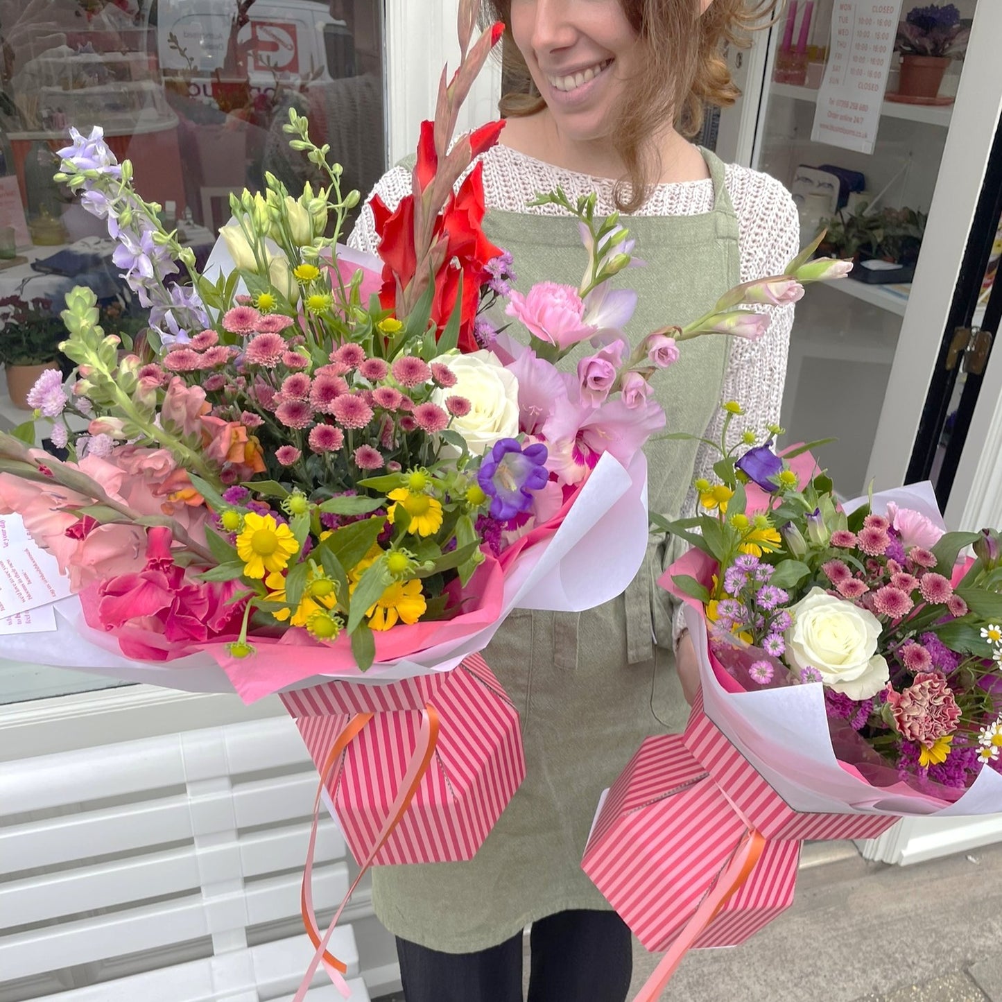 Person holding two bright modern bouquets of stonehaven florist