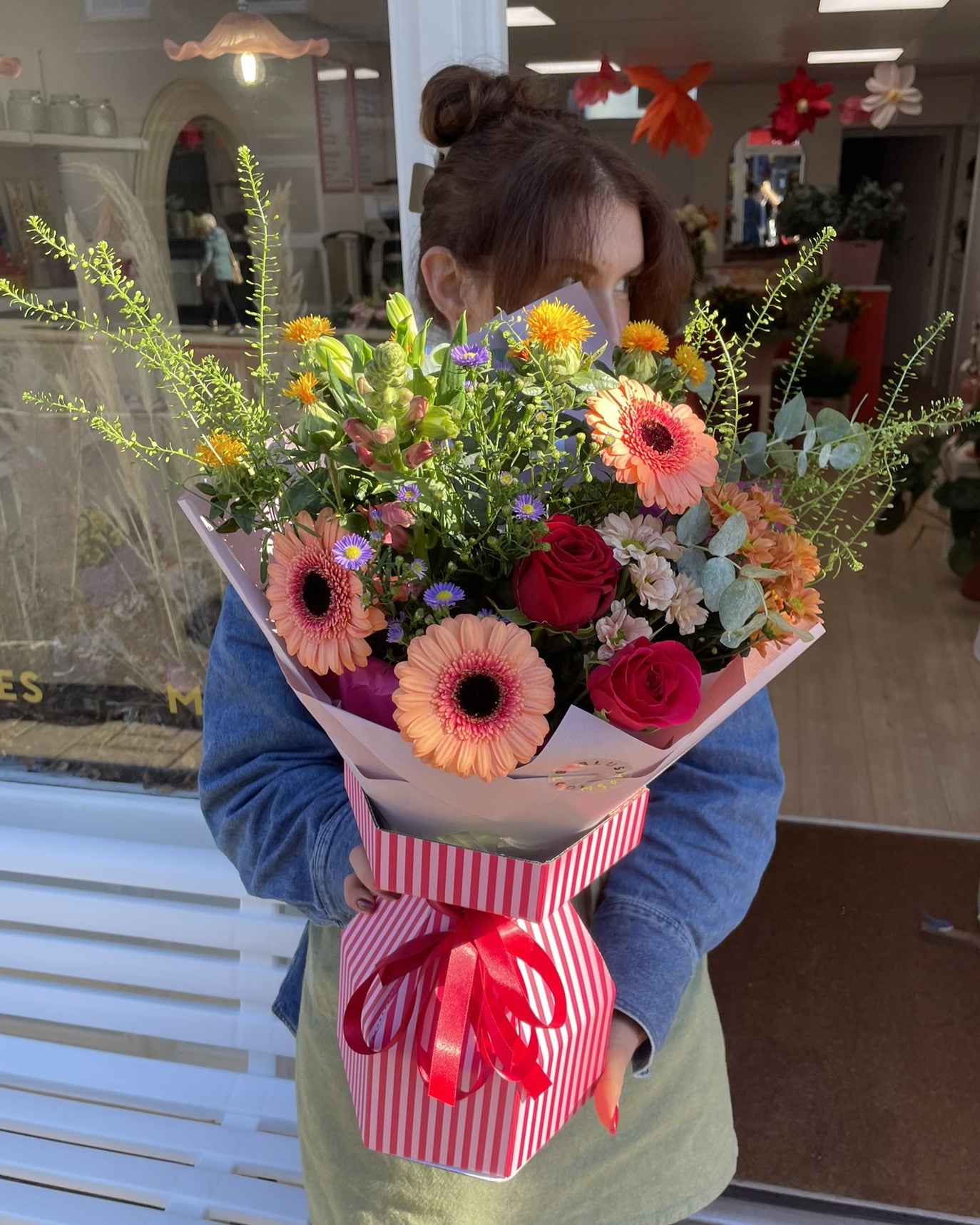Person holding a bouquet outside Blush Blooms, Stonehaven