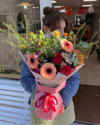 Person holding a bouquet outside Blush Blooms, Stonehaven