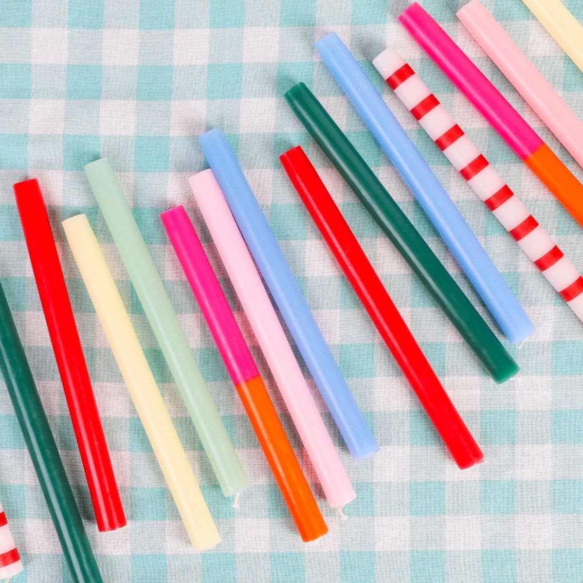 Colorful straws on a checkered tablecloth