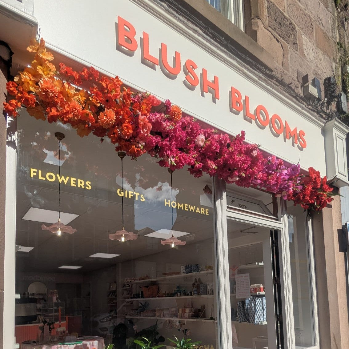 Blush Blooms Stonehaven florist storefront and flower arch