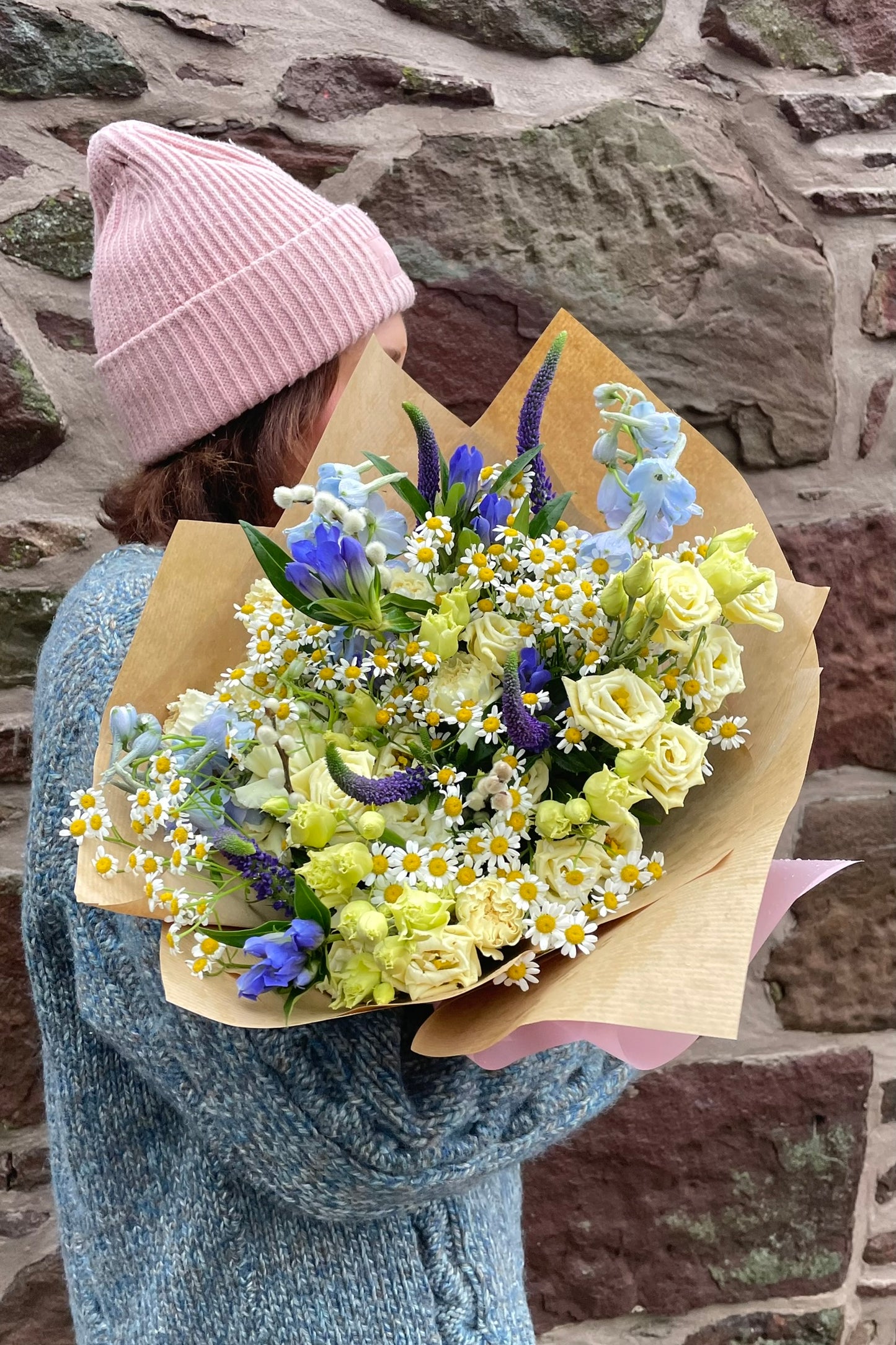 A spring-led cream &amp; butter yellow Valentine’s bouquet featuring lisianthus, delphiniums, daisies, gentiana, veronica &amp; carnations.
