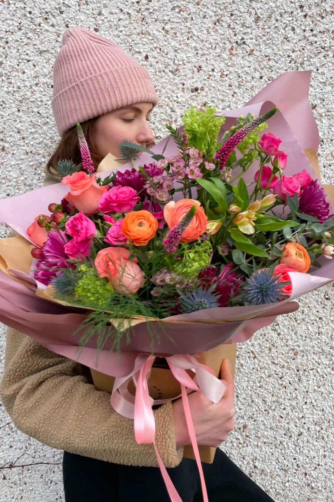 Mother’s Day Florist Choice bouquet by Blush Blooms, featuring pink roses, ranunculus, and seasonal blooms, hand-tied and wrapped in blush paper with ribbon.