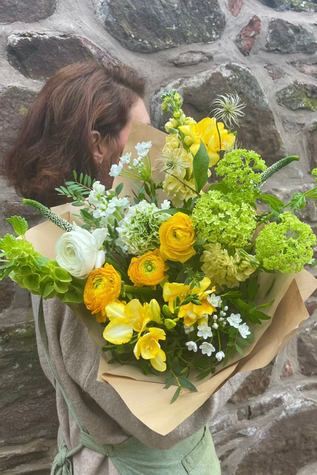 My Sunshine spring bouquet with yellow ranunculus, freesia and fresh green viburnum by Blush Blooms.