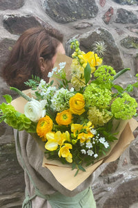 My Sunshine spring bouquet with yellow ranunculus, freesia and fresh green viburnum by Blush Blooms.