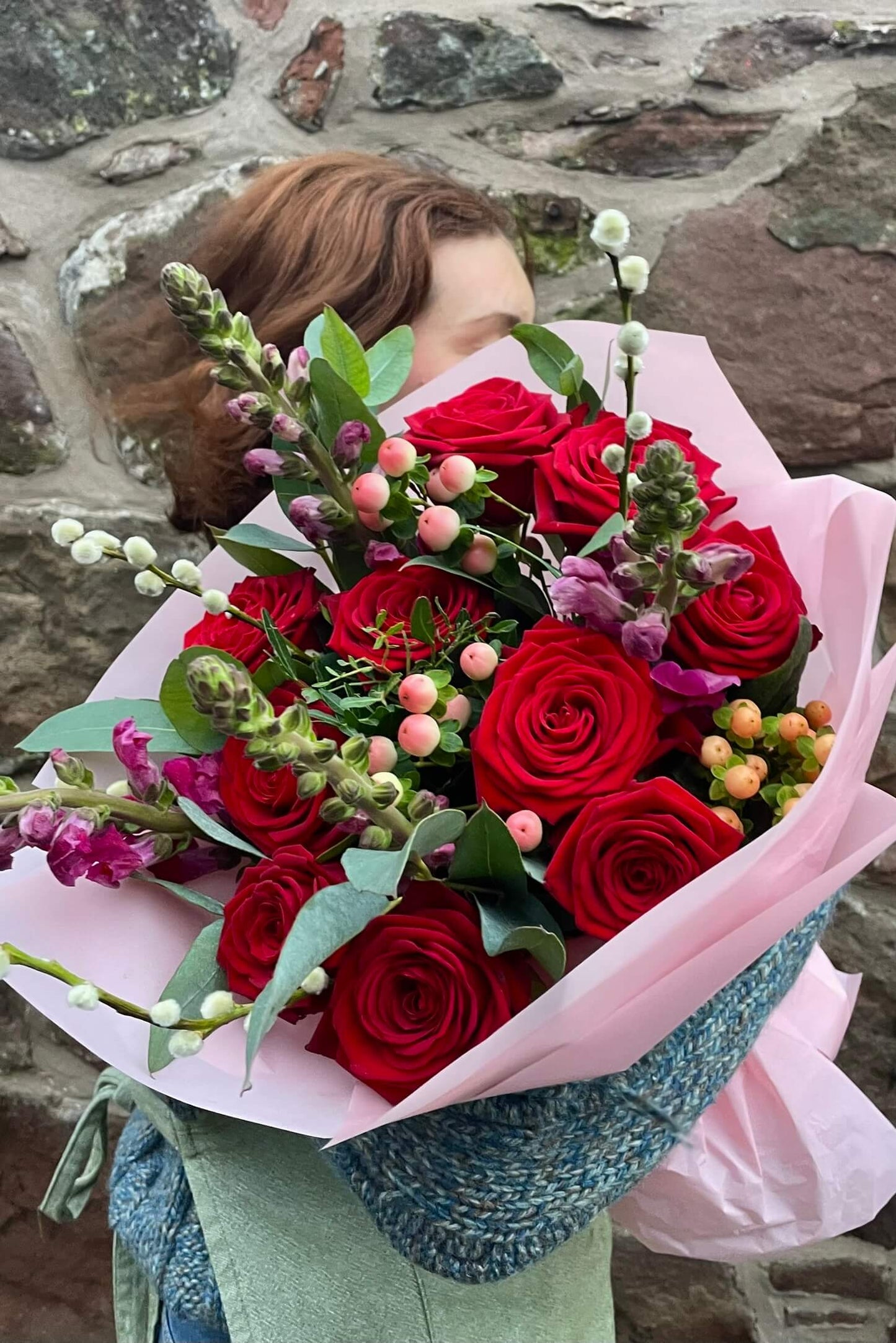 No Ordinary Love Valentine’s bouquet featuring premium Naomi red roses with snapdragon, hypericum berries, pussy-willow and eucalyptus