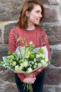 White and green bouquet with spray roses, daisies, ranunculus and viburnum.